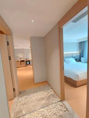 a bedroom with a door leading to a bed at \u66fc\u8c37\u4e1c\u65b9\u9152\u5e97 in Bangkok