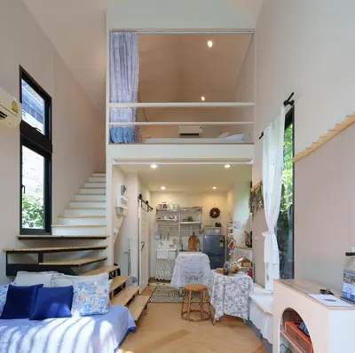 a room with a bed and a staircase at hiddenmoon cottage in Bangkok