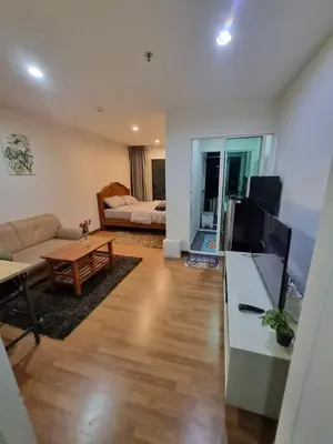 a living room with a television and a living room with a couch at Perfect 1BR at MRT Bangson by B in Bangkok