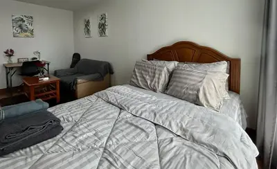 a bedroom with a bed and a chair at Perfect 1BR at MRT Bangson by B in Bangkok