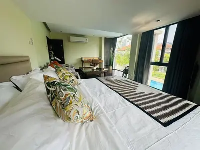 a bedroom with a large white bed with pillows at 5BR Villa with Private Pool Sukhumvit 10mins BTS in Bangkok