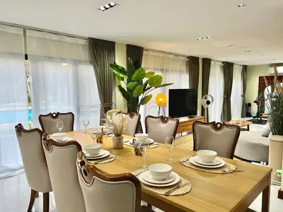 a dining room with a wooden table and chairs at 5BR Villa with Private Pool Sukhumvit 10mins BTS in Bangkok