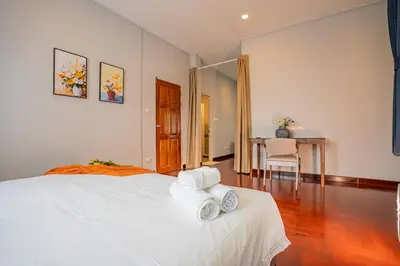 a bedroom with a white bed and a table at 906 Bangkok City Center Single Pool Villa BTS Asok 5 Bedrooms 6 Bathrooms in Bangkok