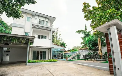 a large white building with a courtyard in front of it at 906 Bangkok City Center Single Pool Villa BTS Asok 5 Bedrooms 6 Bathrooms in Bangkok