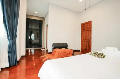a bedroom with a bed and a chair in it at 906 Bangkok City Center Single Pool Villa BTS Asok 5 Bedrooms 6 Bathrooms in Bangkok