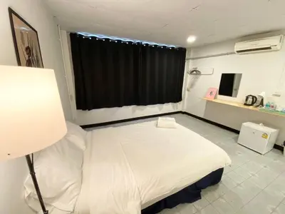 a hospital room with a bed and a window at XX GO INN BTS Ari - BTS Ari Station in Sathani Sam Sen