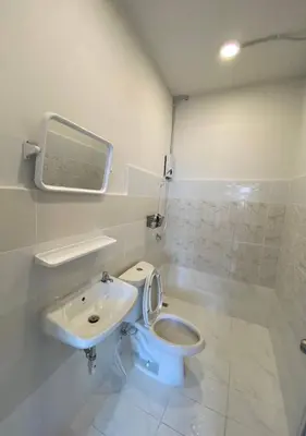 a bathroom with a toilet and a sink at XX GO INN BTS Ari - BTS Ari Station in Sathani Sam Sen