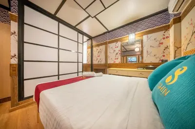a bedroom with a large white bed in a room at SHIN Hotel Victory Monument in Bangkok
