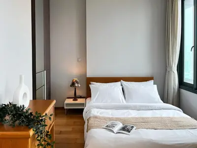 a bedroom with a bed with two books on it at Expansive Loft 2BR - Ultra Fast WiFi - BTS Thonglor in Bangkok