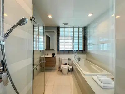 a bathroom with a tub and a toilet and a sink at Expansive Loft 2BR - Ultra Fast WiFi - BTS Thonglor in Bangkok