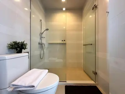 a bathroom with a toilet and a shower at Expansive Loft 2BR - Ultra Fast WiFi - BTS Thonglor in Bangkok