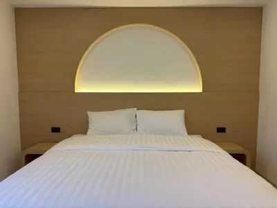 a bedroom with a large bed with an arch above it at Luna Residence in Ban Bang Phai
