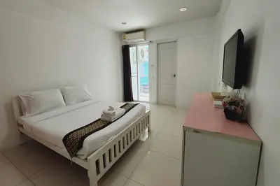 a bedroom with a bed and a television in it at Zenith Life Hotel in Ban Bang Khen (1)