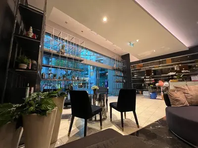 a living room with a table and chairs and a building at Sky Residence in Ekkamai in Bangkok