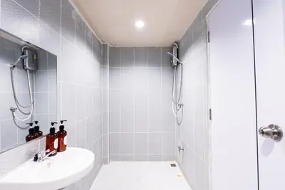 a bathroom with a shower and a sink at Stay On Sukhumvit Soi 11 - สเตย์ ออน สุขุมวิท 11 in Bangkok