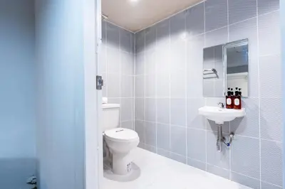 a bathroom with a toilet and a sink at Stay On Sukhumvit Soi 11 - สเตย์ ออน สุขุมวิท 11 in Bangkok