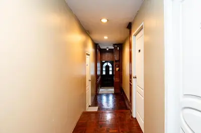 a hallway of a home with wood floors and ceilings at Stay On Sukhumvit Soi 11 - สเตย์ ออน สุขุมวิท 11 in Bangkok