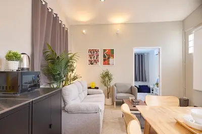 a kitchen and living room with a table and chairs at Cozy&Modern 6-BR Home, 14pax - Central, 5mins BTS in Bangkok