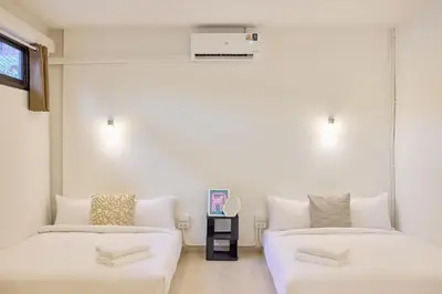 a living room with two beds and a couch at Cozy&Modern 6-BR Home, 14pax - Central, 5mins BTS in Bangkok
