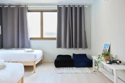 a bedroom with two beds and a window at Cozy&Modern 6-BR Home, 14pax - Central, 5mins BTS in Bangkok