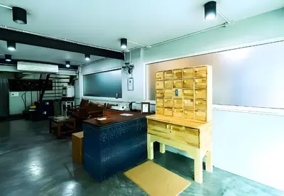 an office with a desk and a table in a room at XX GO INN Khaosan - โกอินน์ ถนนข้าวสาร in Bangkok