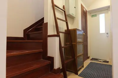 a wooden staircase in a room with a door at Entire Home 2BR 2BA Chinatown near Yaowarat - Songwat in Bangkok