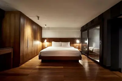 a bedroom with a large bed in a room at XX Wish Inn Silom BKK - วิช อินน์ สีลม in Bang Rak