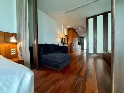 a living room with a blue couch and a chair at XX Wish Inn Silom BKK - วิช อินน์ สีลม in Bang Rak