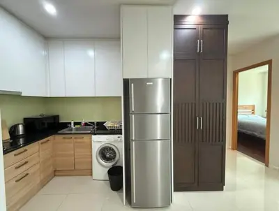 a kitchen with a refrigerator and a washer and dryer at The Condo C - Luxury Condo with Onsen in Bangkok