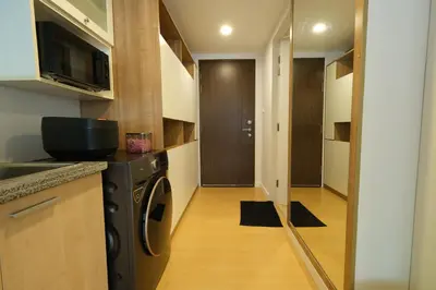 a kitchen with a washer and dryer in a room at The Silent Sanctum in Bangkok