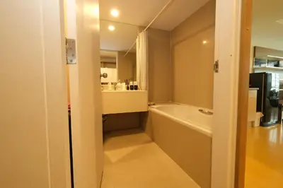 a bathroom with a bath tub and a sink at The Silent Sanctum in Bangkok