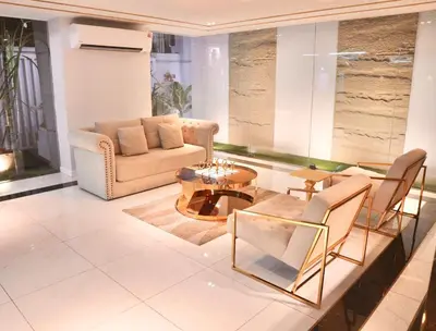 a living room with a couch and a table and chairs at ICON NARINDRA SUITES HOTEL Sukhumvit Bangkok Thailand 50sqm to 90sqm Rooms & FREE Minibar in Bangkok