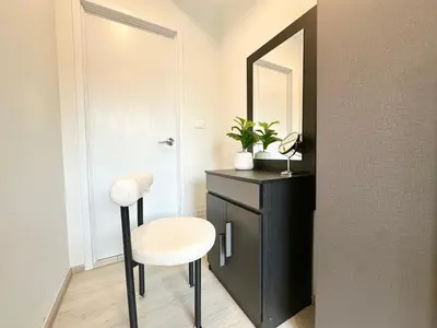 a bathroom with a stool and a mirror at Cosy apartment in Bangkok