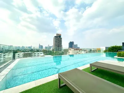 a large swimming pool on the roof of a building at Cosy apartment in Bangkok