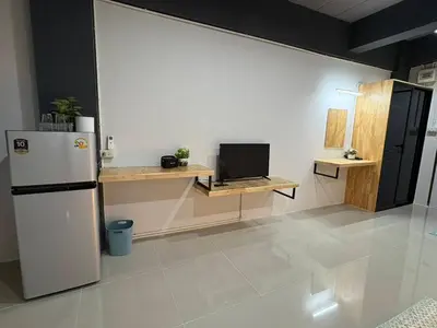 a kitchen with a refrigerator and a desk with a laptop at Irich Bang Hua Suae 6kms from BTS Pu-Chao in Ban Bang Chak