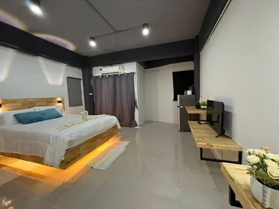 a large bedroom with a large bed and a table at Irich Bang Hua Suae 6kms from BTS Pu-Chao in Ban Bang Chak