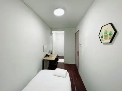 a small room with a bed and a desk at XX GO INN Siriraj BKK - โกอินน์ ศิริราช in Bangkok Noi