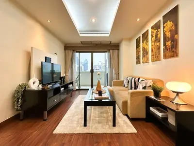 a living room with a couch and a tv at Vibrant Modern 57 SQM - Ultra Fast WiFi - BTS Thonglor in Bangkok