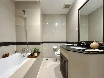 a bathroom with a tub and a toilet and a sink at Vibrant Modern 57 SQM - Ultra Fast WiFi - BTS Thonglor in Bangkok