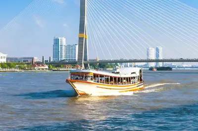 a boat on the water in front of a bridge at XX GO INN Khaosan - โกอินน์ ถนนข้าวสาร in Bangkok