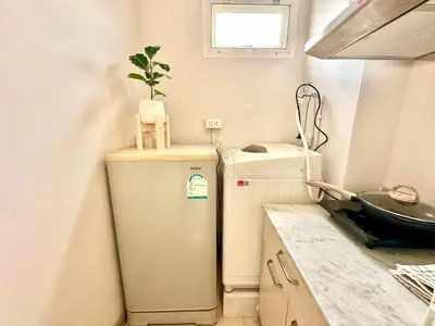 a small kitchen with a refrigerator and a plant on top at Studio with view near Ekkamai in Bangkok