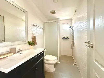 a bathroom with a sink and a toilet and a shower at Cosy 2 bedrooms near Ekkamai in Bangkok