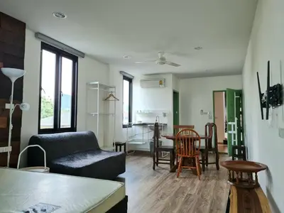 a living room with a couch and a table at Lee Home Bangkok in Bangkok