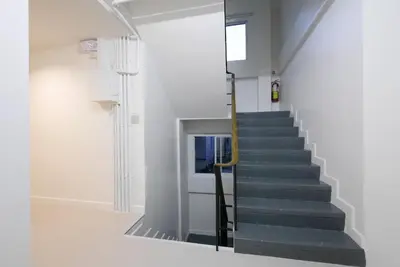 a staircase in a building with a stair case at Lee Home Bangkok in Bangkok