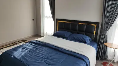 a bed with blue sheets and blue pillows in a bedroom at Lumpini park chatuchak in Bangkok
