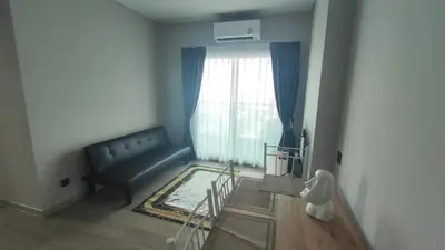 a living room with a couch and a window at Lumpini park chatuchak in Bangkok
