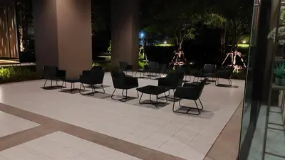 a group of chairs and tables in a courtyard at night at Lumpini park chatuchak in Bangkok
