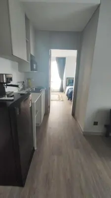 a kitchen with a hallway leading to a bedroom at Lumpini park chatuchak in Bangkok