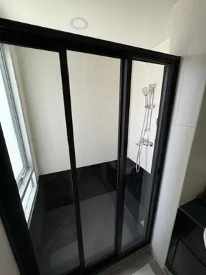 a sliding glass door with a ladder in a room at 2 Bed Condo in the Heart of Bangkok in Bangkok