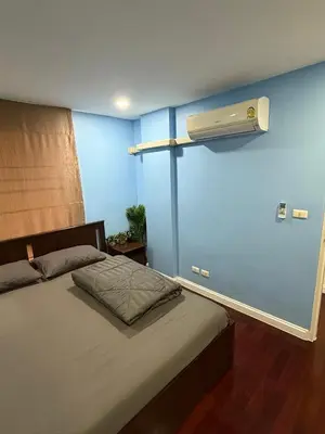a bedroom with a bed with a blue wall at 2 Bed Condo in the Heart of Bangkok in Bangkok